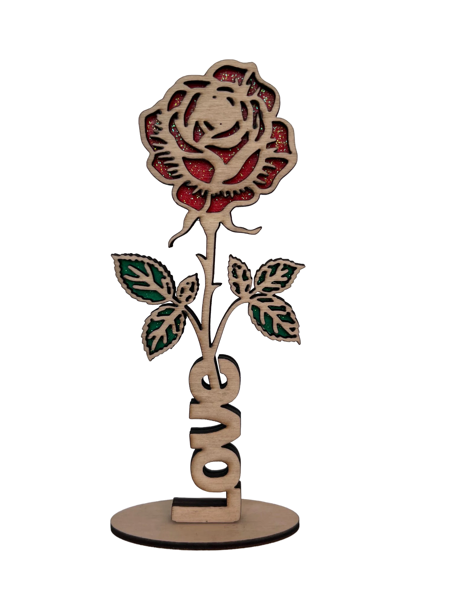 Rose en bois découpée au laser aux pétales rouges pailletés et feuilles vertes, mot Love à la base, posée sur un socle rond
