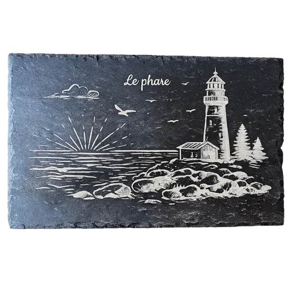 Ardoise noire gravée d'un phare sur les rochers au coucher de soleil, avec maisonnette et sapins